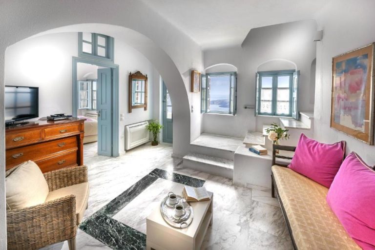 a living room with a couch and a tv at Aigialos Luxury Traditional Settlement in Fira 768x512