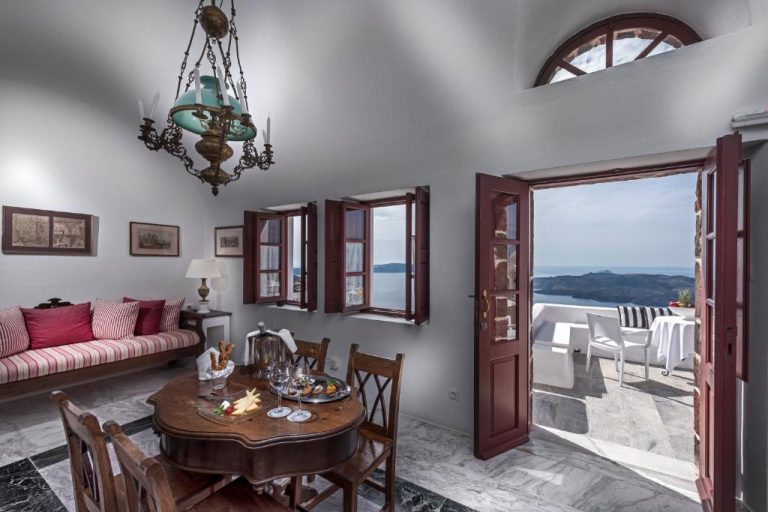 a living room with a table and a couch at Aigialos Luxury Traditional Settlement in Fira 768x512