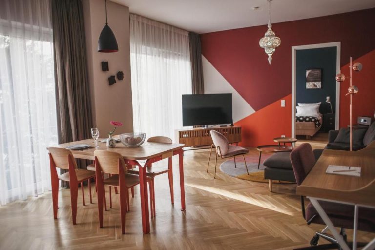 a living room with a table and a television at The Circus Apartments in Berlin 768x512