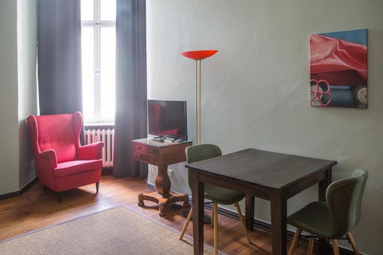 a living room with a table and chairs and a lamp at Hotel Art Nouveau am Kurfurstendamm in Berlin 768x512
