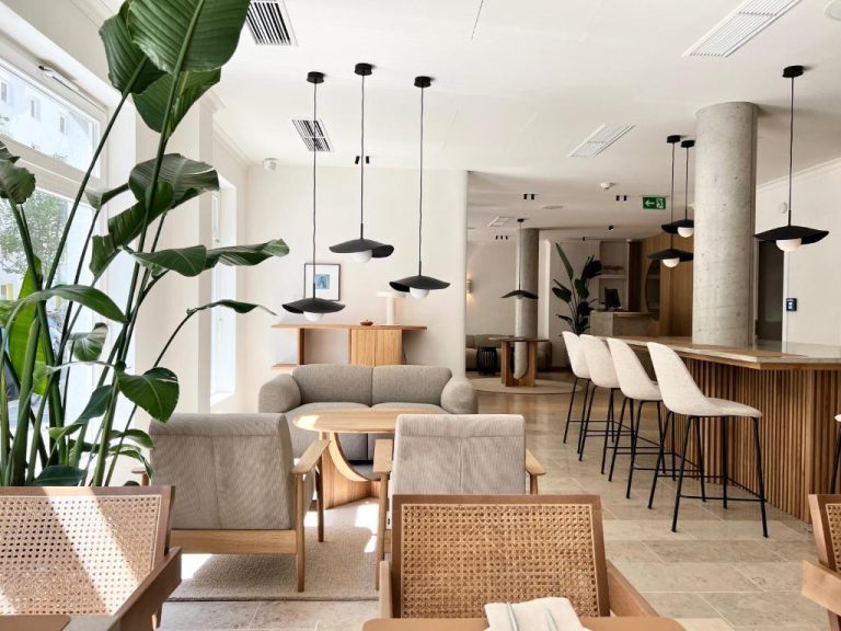 a living room with a table and chairs at ADELANTE Boutique Hotel in Berlin 768x576