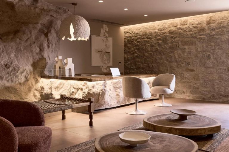 a lobby with chairs and a table and a counter at Ethereum Luxury Suites a member of Mykonos Highlights in Mikonos 768x512