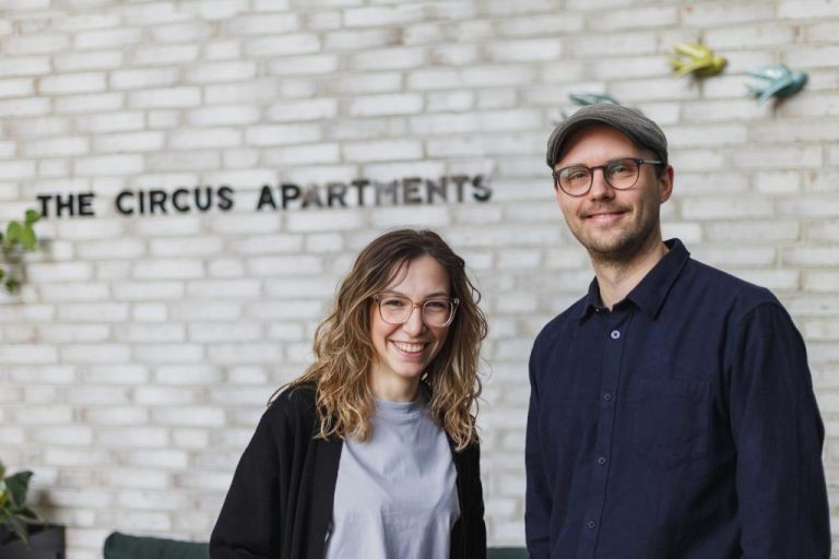 a man and a woman standing in front of a building at The Circus Apartments in Berlin 768x512