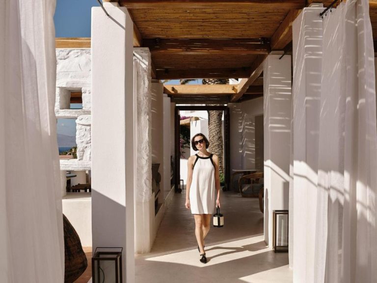 a model walks down a hallway in a dress at Boheme Mykonos Town Small Luxury Hotels of the World in Mikonos 768x576