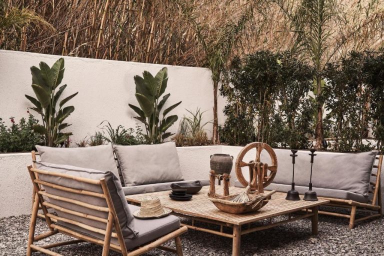 a patio with a couch and a table and chairs at Amyth of Mykonos Agios Stefanos in Agios Stefanos 768x512