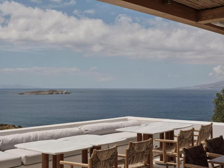 a patio with tables and chairs and the ocean at Boheme Mykonos Town Small Luxury Hotels of the World in Mikonos 768x576