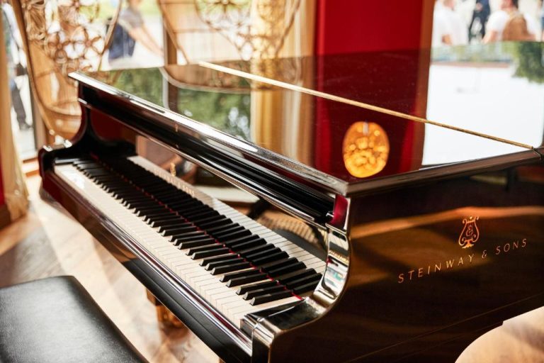 a piano with a cookie sitting on top of it at Orania.Berlin in Berlin 768x512