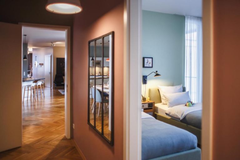a room with a bed and a mirror and a bedroom at The Circus Apartments in Berlin 768x512