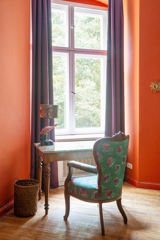 a room with a chair and a table and a window at Hotel Art Nouveau am Kurfurstendamm in Berlin
