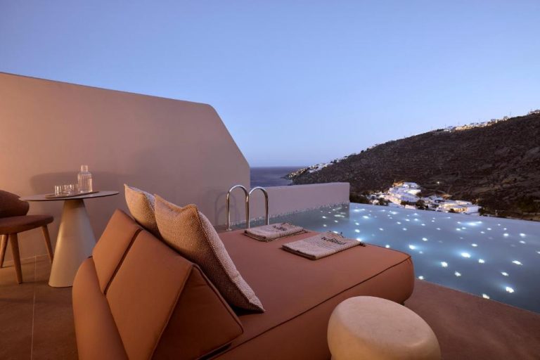 a room with a couch and a view of the ocean at Ethereum Luxury Suites a member of Mykonos Highlights in Mikonos 768x512