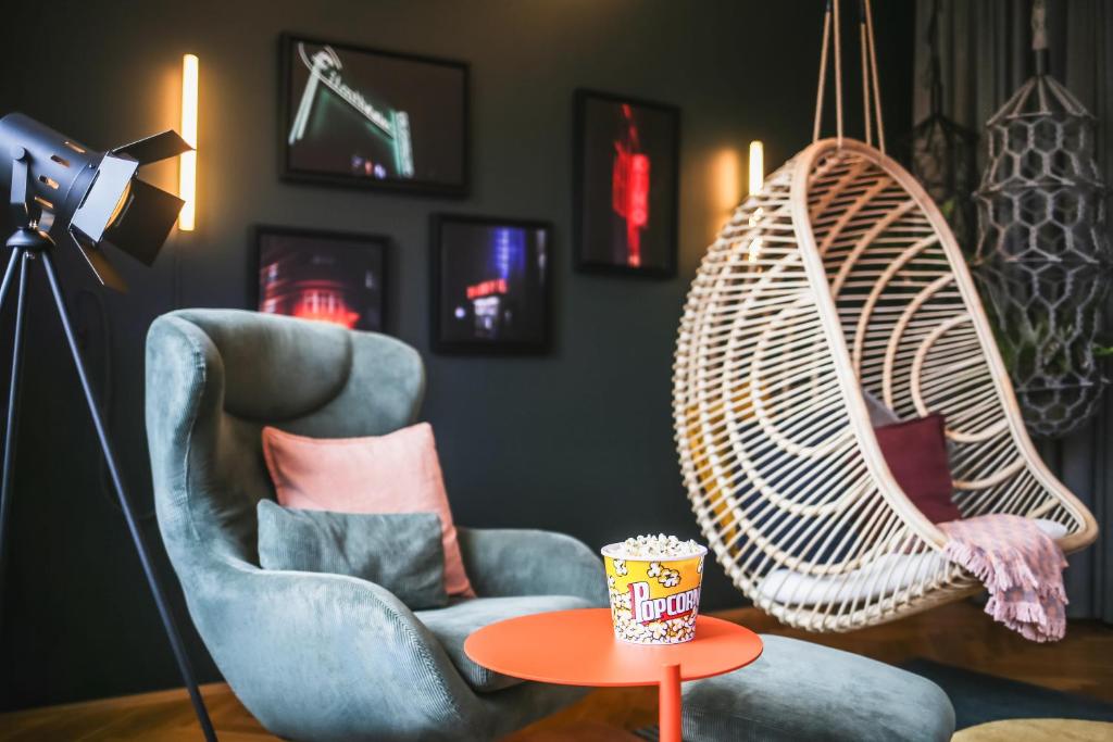 a room with a swing and a chair and a table at The Circus Apartments in Berlin