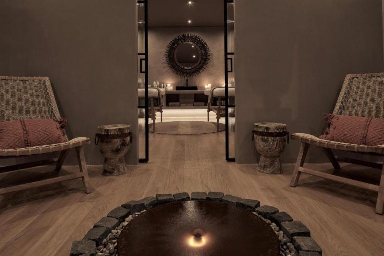 a room with a table and chairs and a mirror at Amyth of Mykonos Agios Stefanos in Agios Stefanos 768x512