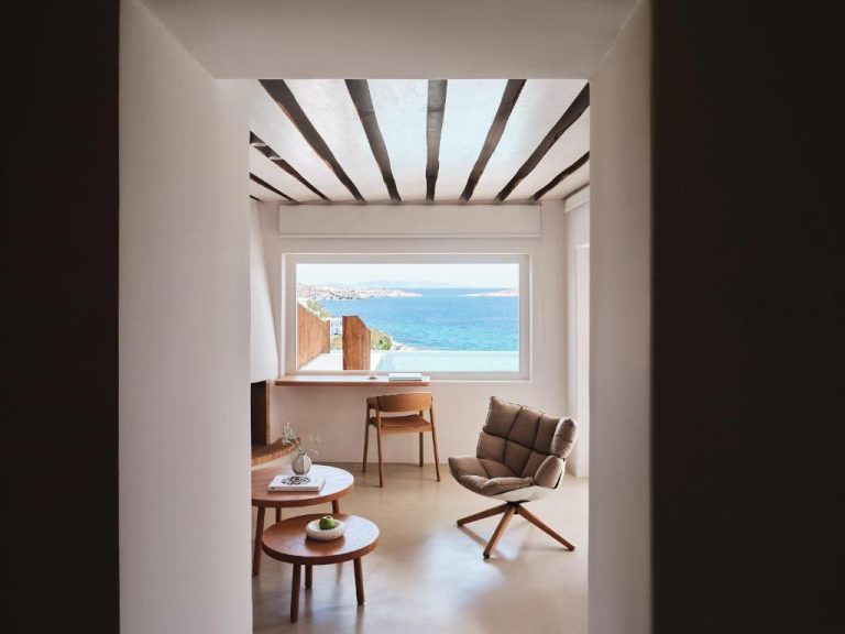 a room with a window and a chair and a table at BillCoo Mykonos The Leading Hotels of the World in Mikonos 768x576