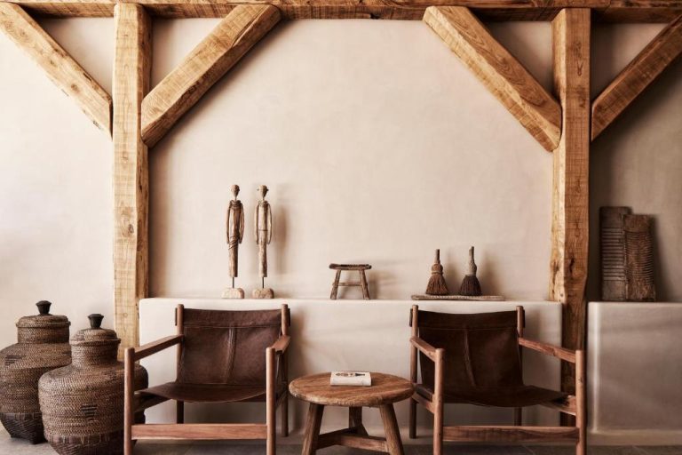 a room with two chairs and a table with vases at Amyth of Mykonos Agios Stefanos in Agios Stefanos 768x512
