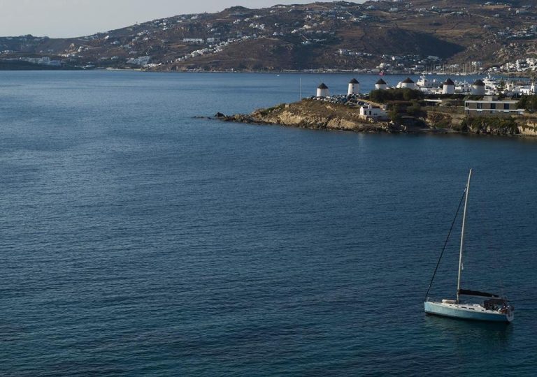 a sailboat in the middle of a large body of water at Bonzoe Suites Villas in Mikonos 1 768x540