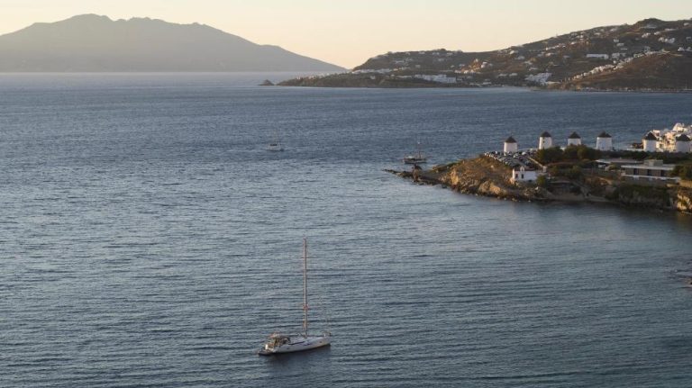a sailboat in the middle of a large body of water at Bonzoe Suites Villas in Mikonos 768x431