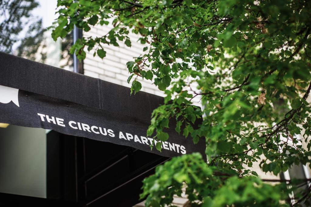 a sign that reads the chrysalisarinearinearts in front of a tree at The Circus Apartments in Berlin