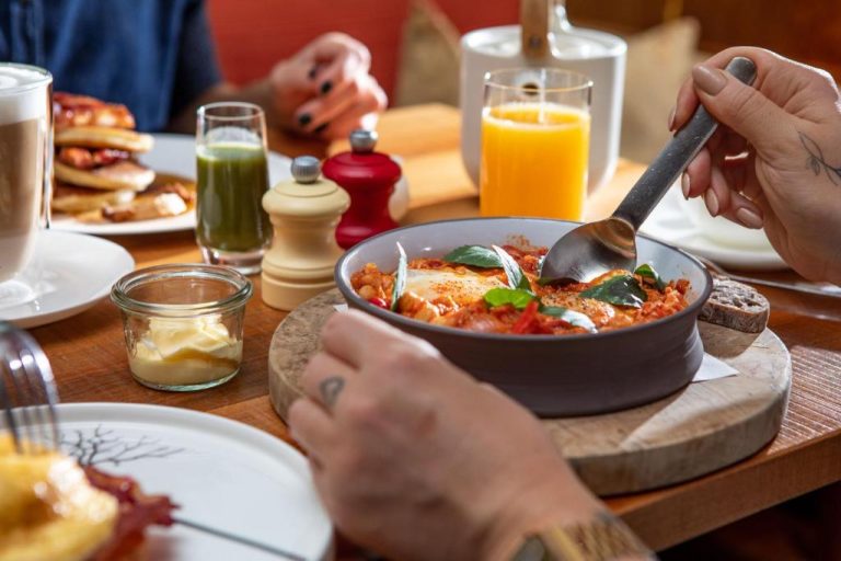 a table with a bowl of food with a spoon at Orania.Berlin in Berlin 768x512