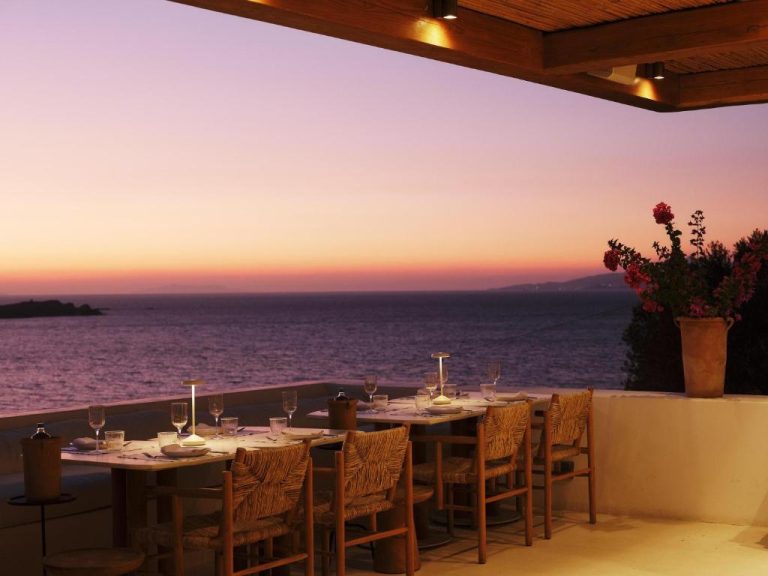 a table with chairs and a view of the ocean at Boheme Mykonos Town Small Luxury Hotels of the World in Mikonos 768x576