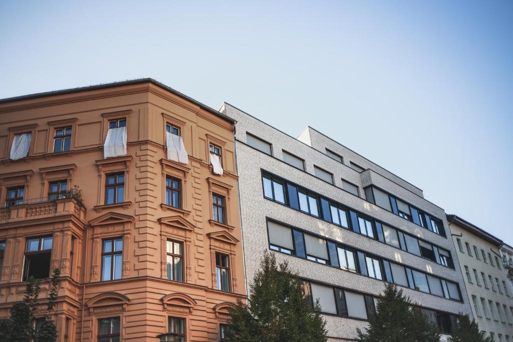 a tall building next to a brick building at The Circus Apartments in Berlin