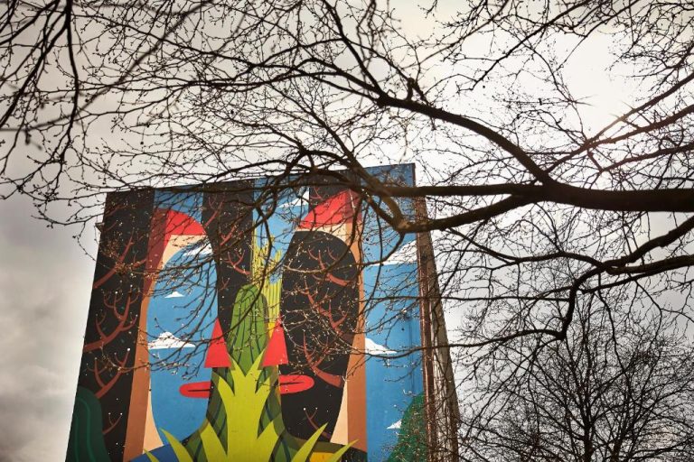a tall building with a painting on the side of it at Orania.Berlin in Berlin 768x512