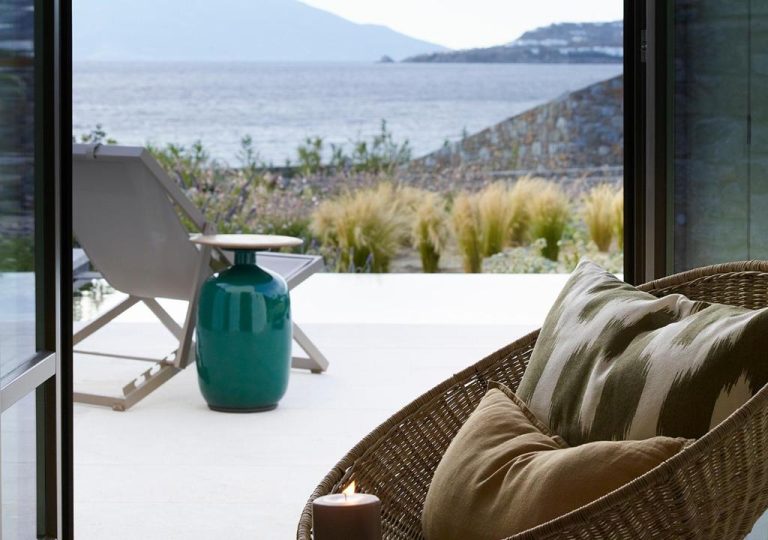 a vase sitting in a wicker chair on a patio at Bonzoe Suites Villas in Mikonos 768x540