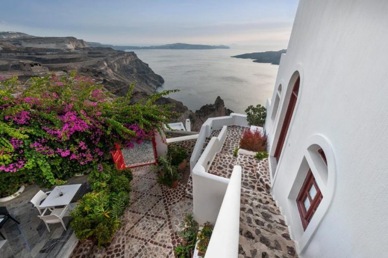 a view of the ocean from the balcony of a white building at Aigialos Luxury Traditional Settlement in Fira 768x512