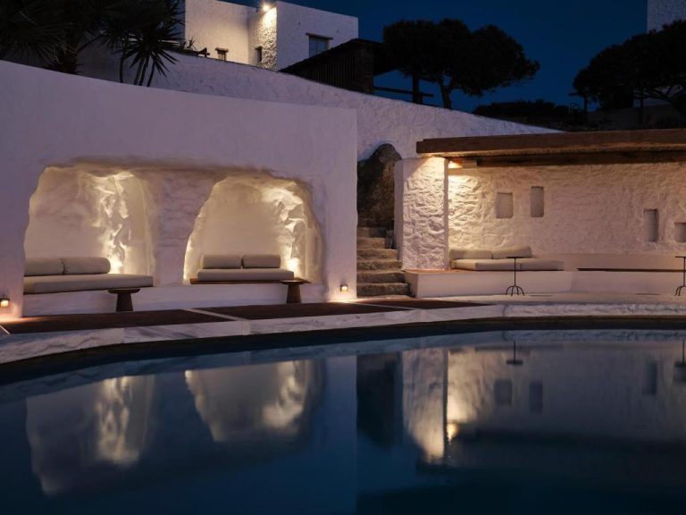 a villa with a swimming pool at night at Boheme Mykonos Town Small Luxury Hotels of the World in Mikonos 768x576