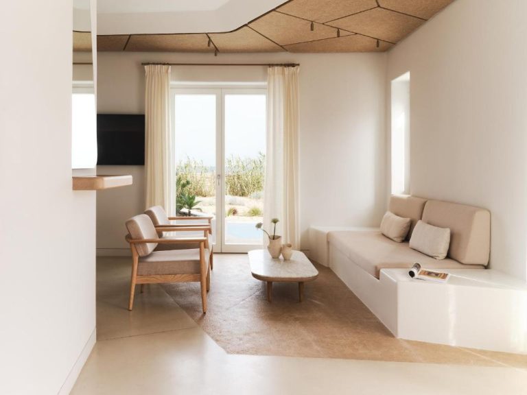 a white living room with a couch and a chair at BillCoo Mykonos The Leading Hotels of the World in Mikonos 768x576