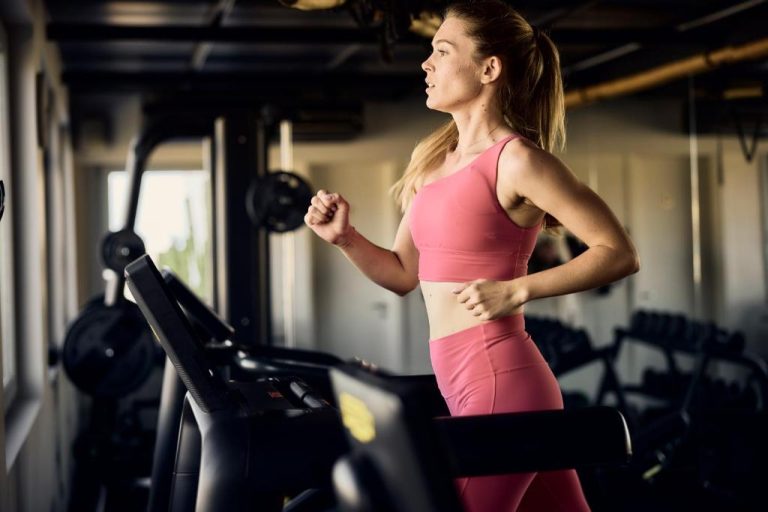 a woman running on a treadmill in a gym at Ethereum Luxury Suites a member of Mykonos Highlights in Mikonos 768x512
