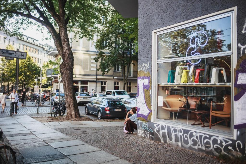 a woman sitting in front of a store window at The Circus Apartments in Berlin