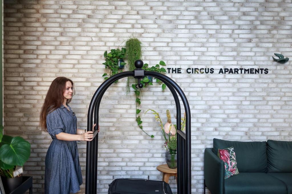 a woman standing in front of a brick wall at The Circus Apartments in Berlin