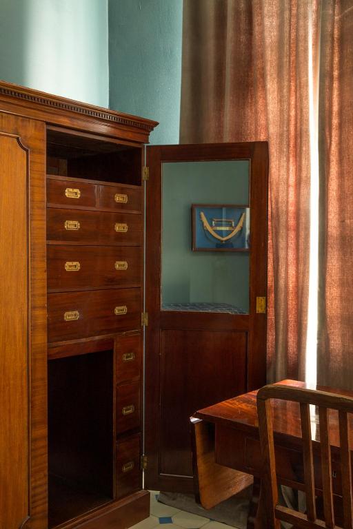 a wooden cabinet with a desk next to a dresser at Hotel Art Nouveau am Kurfurstendamm in Berlin