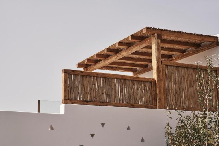 a wooden roof on top of a white wall at Amyth of Mykonos Agios Stefanos in Agios Stefanos 768x512