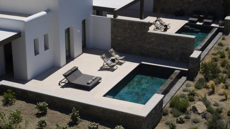 an aerial view of a house with a swimming pool at Bonzoe Suites Villas in Mikonos 768x431