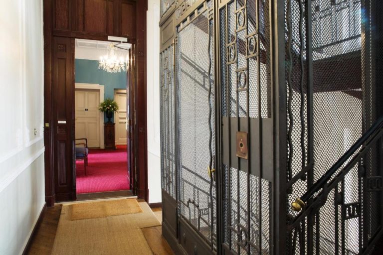 an entrance to a hallway with a wrought iron door at Hotel Art Nouveau am Kurfurstendamm in Berlin 768x512