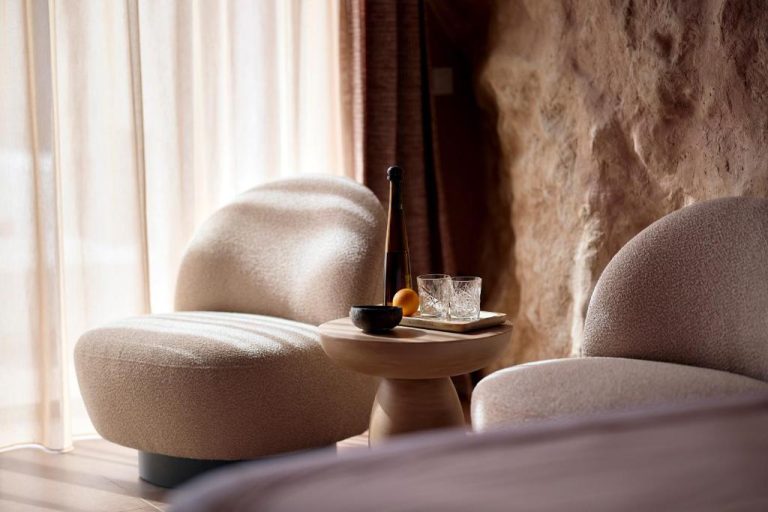two chairs and a table in a room with a window at Ethereum Luxury Suites a member of Mykonos Highlights in Mikonos 768x512