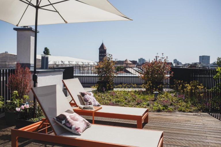 two chairs and an umbrella on a roof at The Circus Apartments in Berlin 768x512
