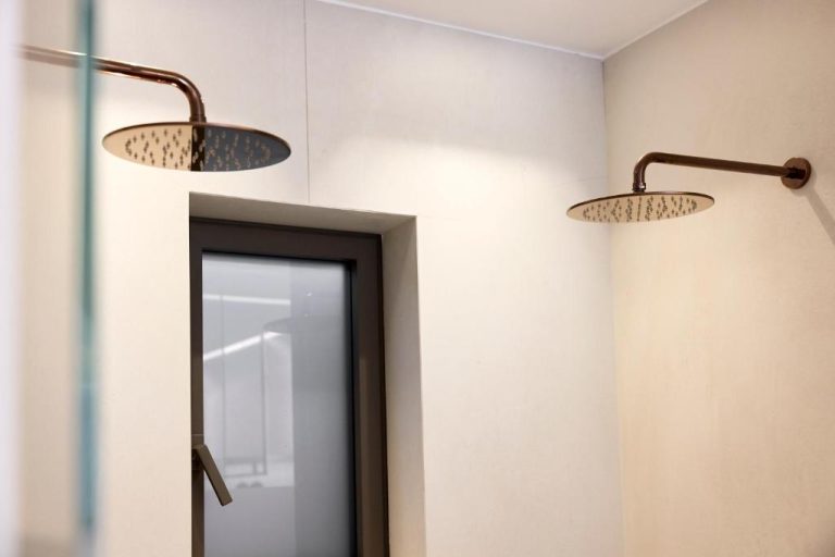 two lights above a mirror in a bathroom at Ethereum Luxury Suites a member of Mykonos Highlights in Mikonos 768x512